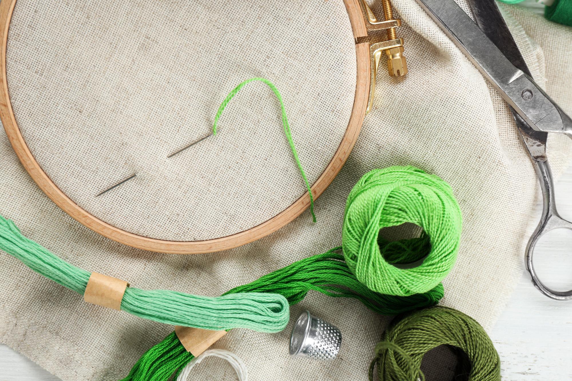 Studio workspace with embroidery hoops and thread